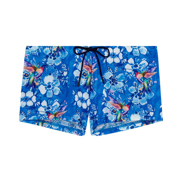Blue floral and bird patterned shorts on a white background